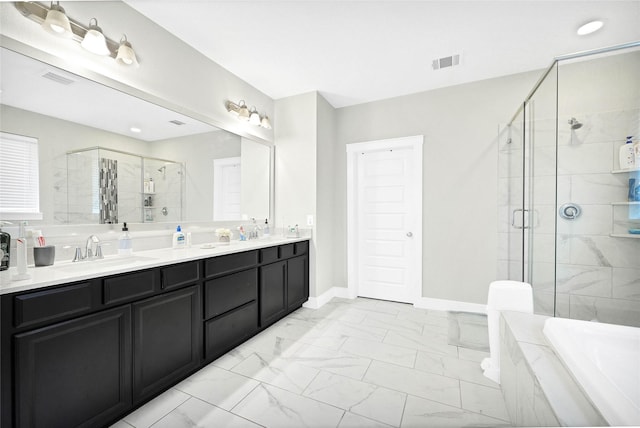 bathroom with visible vents, tiled tub, a stall shower, marble finish floor, and a sink