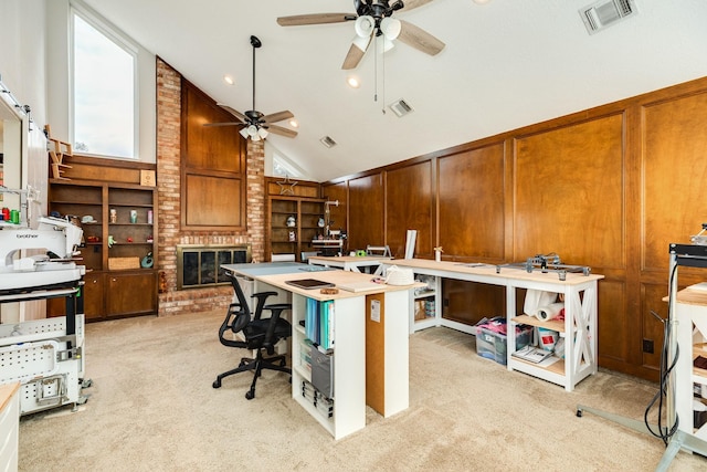 home office with high vaulted ceiling, visible vents, light colored carpet, and a fireplace