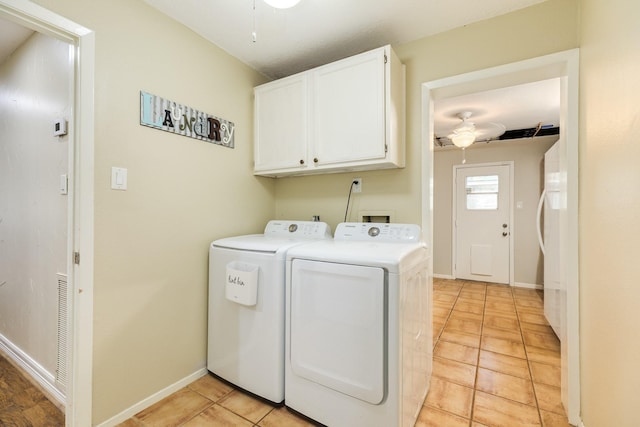 washroom with baseboards, ceiling fan, washing machine and dryer, light tile patterned floors, and cabinet space