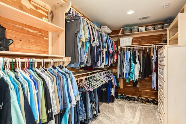 walk in closet with visible vents and carpet floors