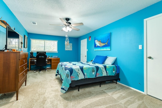 bedroom with visible vents, baseboards, carpet flooring, a textured ceiling, and a ceiling fan