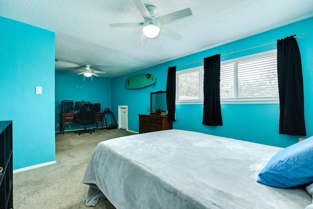 bedroom featuring baseboards, carpet floors, a textured ceiling, and ceiling fan