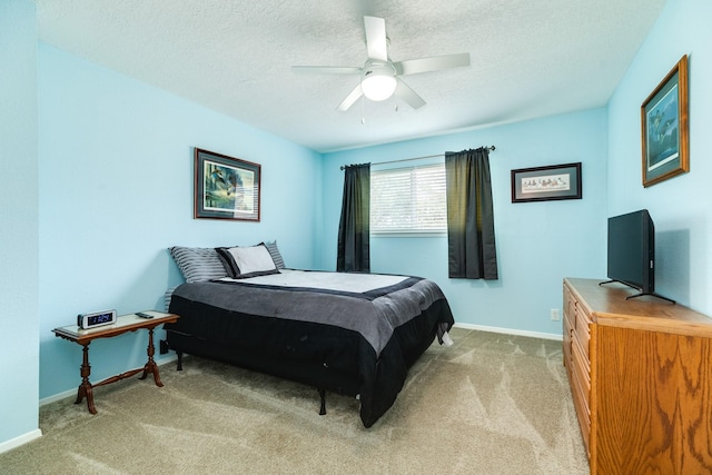 bedroom featuring a textured ceiling, baseboards, and light carpet