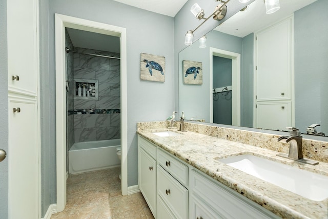 bathroom with a sink, shower / bath combination, toilet, and double vanity