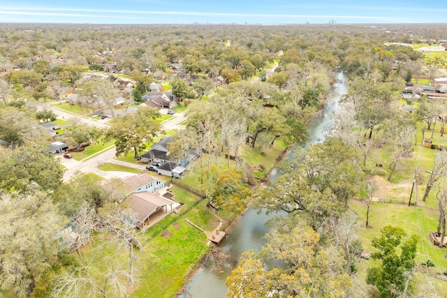 bird's eye view featuring a view of trees and a water view