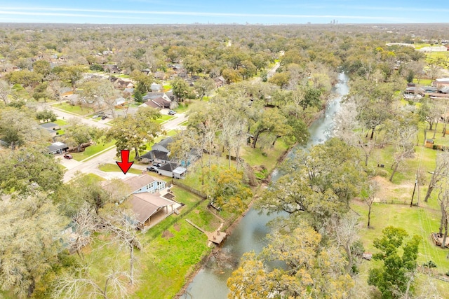 aerial view with a wooded view and a water view