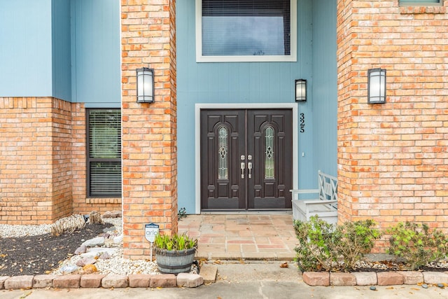 property entrance featuring brick siding