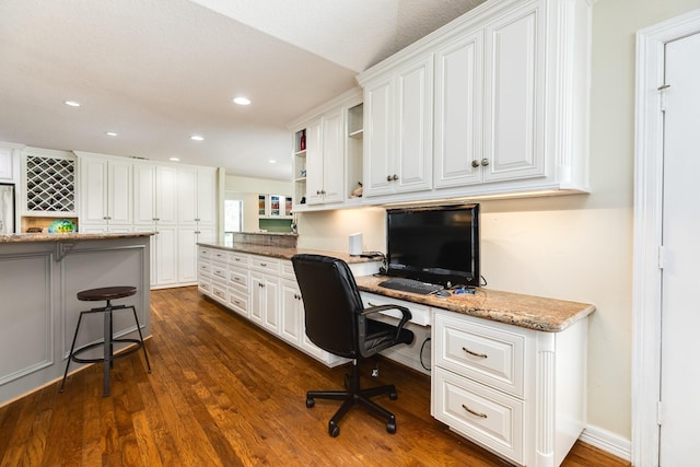 home office featuring recessed lighting, dark wood-style floors, and built in desk