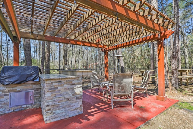 view of patio with fence, area for grilling, a grill, and a pergola