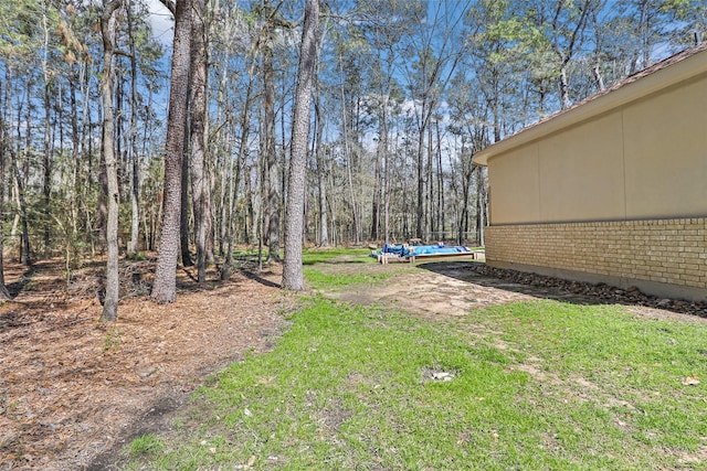 view of yard featuring a wooded view