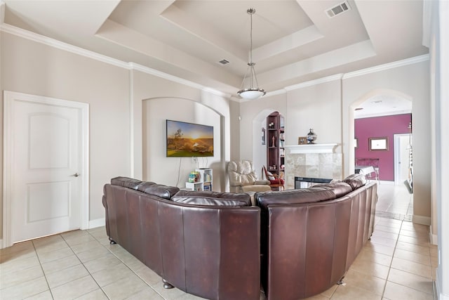 21971 Blazing Trl, New Caney, TX 77357 - living room with arched walkways, a tray ceiling, visible vents, and light tile patterned floors