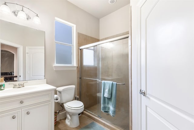 full bath featuring tile patterned floors, a stall shower, toilet, and vanity