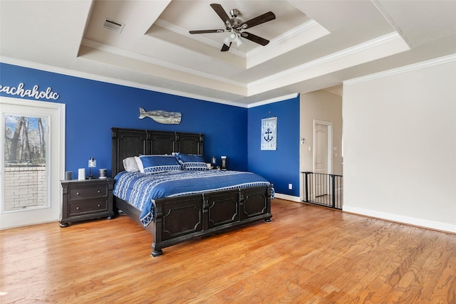 21971 Blazing Trl, New Caney, TX 77357 - bedroom with a tray ceiling, crown molding, light wood-type flooring, baseboards, and visible vents