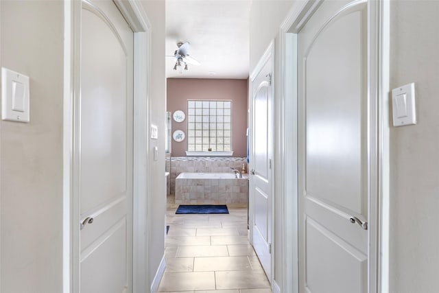 bathroom with tile patterned flooring, a garden tub, and ceiling fan