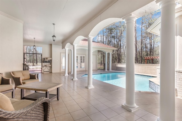 pool featuring french doors and a patio area