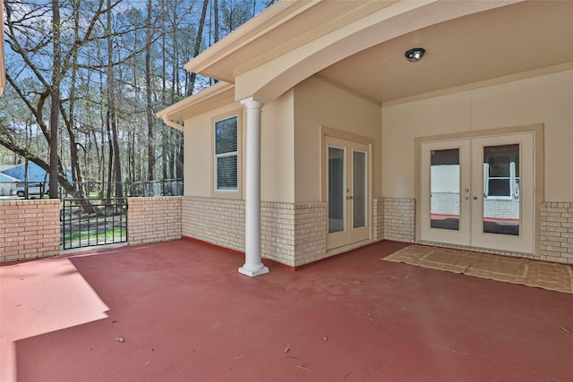 view of patio with french doors and fence