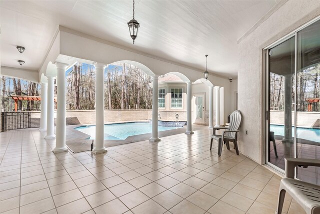 view of swimming pool featuring ornate columns