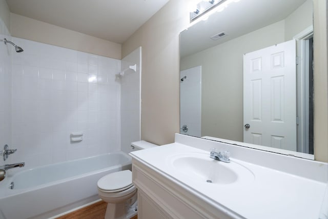 full bath featuring vanity, wood finished floors, visible vents, shower / bathing tub combination, and toilet