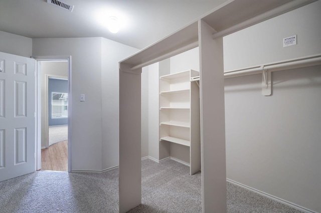 spacious closet with visible vents and carpet floors