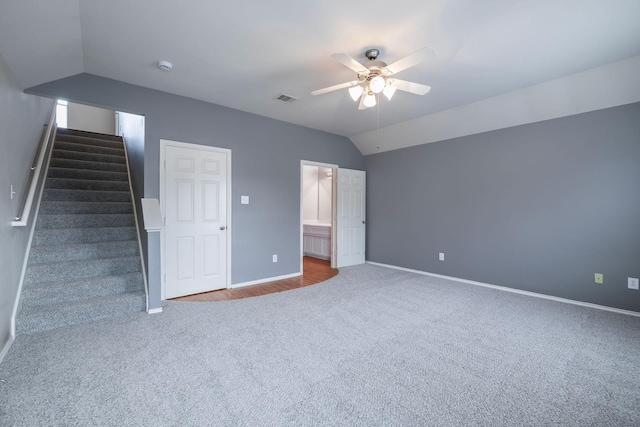 interior space with baseboards, carpet floors, visible vents, and vaulted ceiling