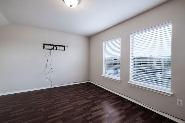 unfurnished room featuring dark wood finished floors and baseboards