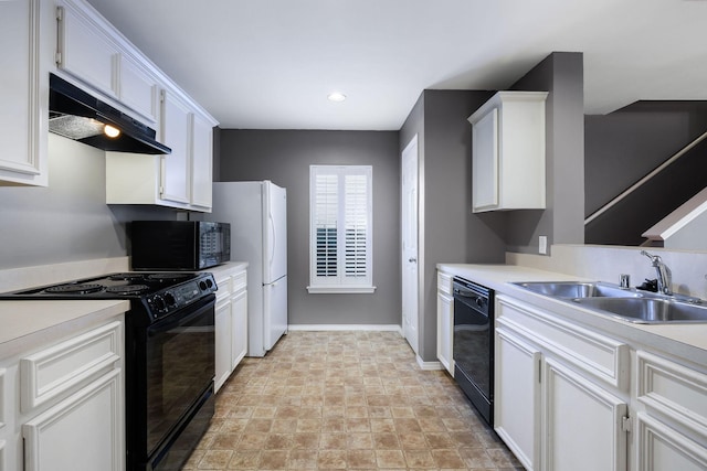 kitchen featuring under cabinet range hood, black appliances, light countertops, and a sink