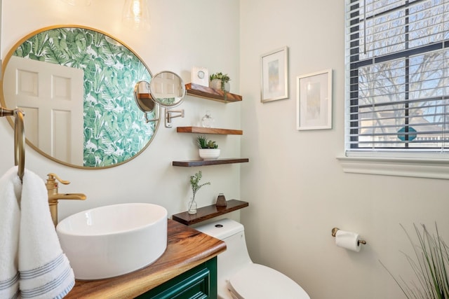 bathroom featuring toilet and vanity