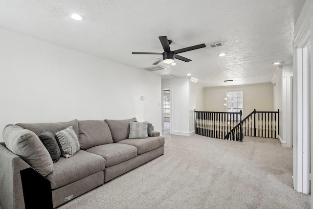 living room featuring recessed lighting, visible vents, carpet flooring, and a textured ceiling