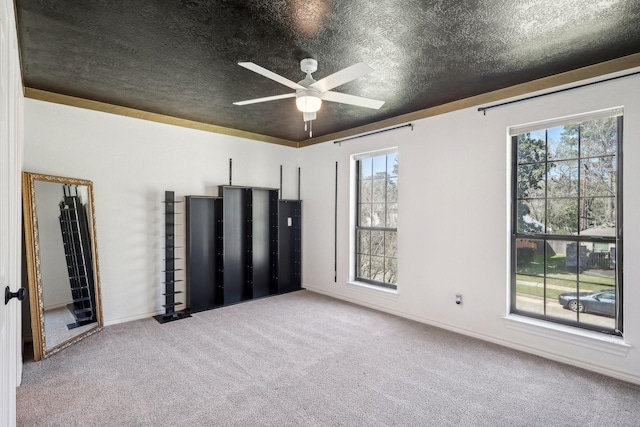 unfurnished bedroom featuring a textured ceiling, ceiling fan, and carpet floors