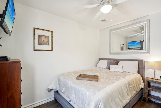 bedroom featuring baseboards, visible vents, dark wood-style flooring, and ceiling fan