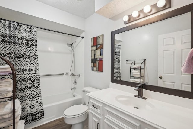 bathroom with toilet, vanity, shower / tub combo, wood finished floors, and a textured ceiling