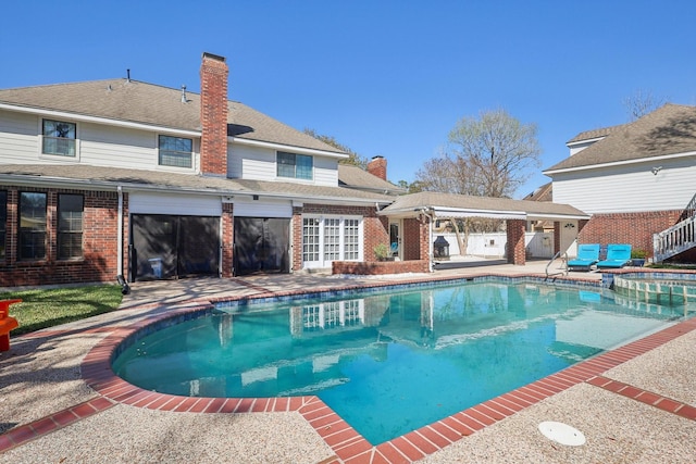 view of pool featuring a pool with connected hot tub and a patio