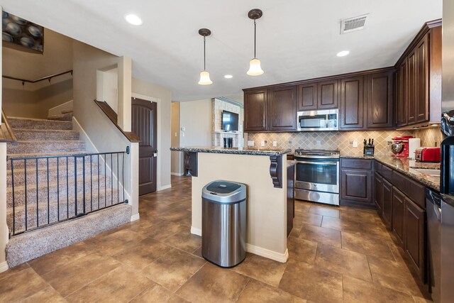 3822 Dove Hollow Ln, College Station, TX 77845 - kitchen featuring dark stone countertops, visible vents, decorative backsplash, dark brown cabinets, and appliances with stainless steel finishes