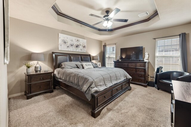 3822 Dove Hollow Ln, College Station, TX 77845 - bedroom featuring visible vents, crown molding, baseboards, light carpet, and a raised ceiling