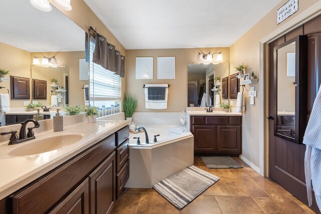 3822 Dove Hollow Ln, College Station, TX 77845 - bathroom featuring a sink, two vanities, a bath, and tile patterned floors