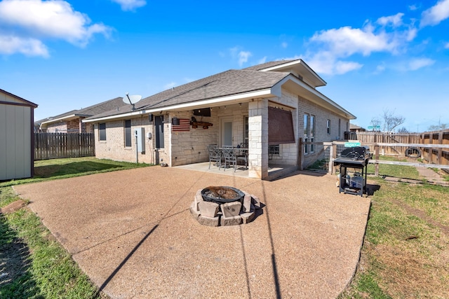 3822 Dove Hollow Ln, College Station, TX 77845 - back of property featuring a patio, a yard, a fenced backyard, a fire pit, and brick siding