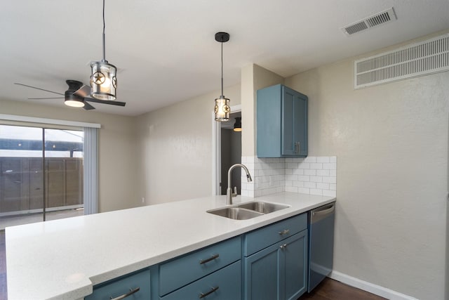 kitchen with dishwasher, blue cabinetry, visible vents, and a sink