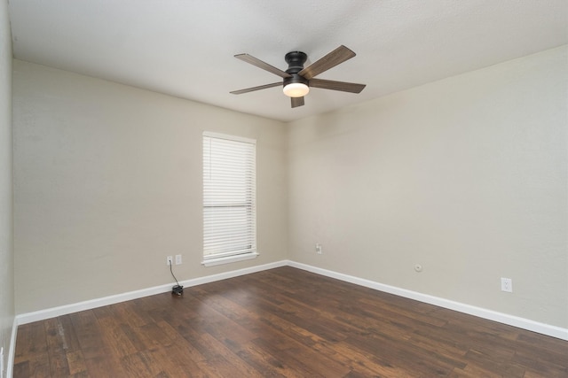 spare room featuring ceiling fan, baseboards, and dark wood-style flooring