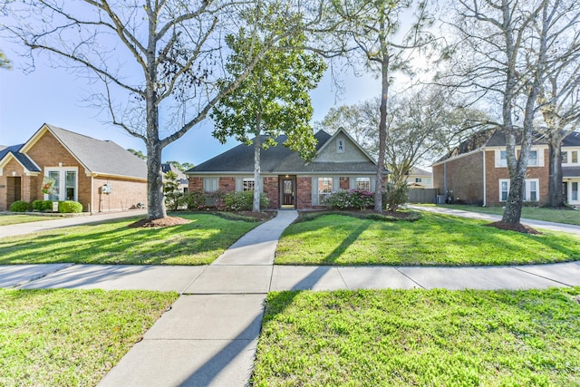 view of front of house featuring brick siding and a front lawn