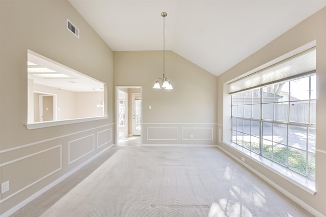 unfurnished dining area featuring carpet, visible vents, lofted ceiling, a decorative wall, and a chandelier