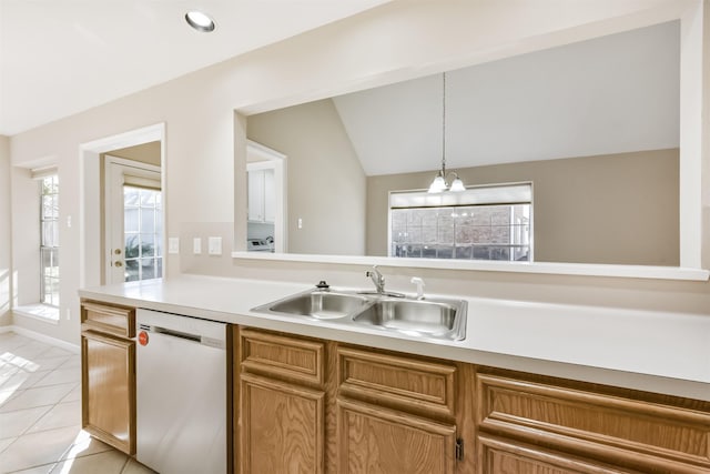 kitchen featuring a sink, decorative light fixtures, light countertops, light tile patterned floors, and dishwashing machine