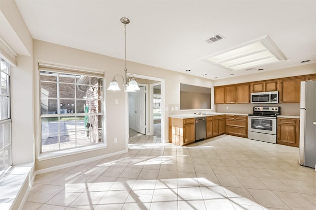 kitchen featuring visible vents, light countertops, an inviting chandelier, brown cabinetry, and stainless steel appliances