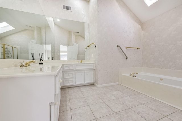 full bathroom featuring tile patterned floors, visible vents, lofted ceiling with skylight, and a bath