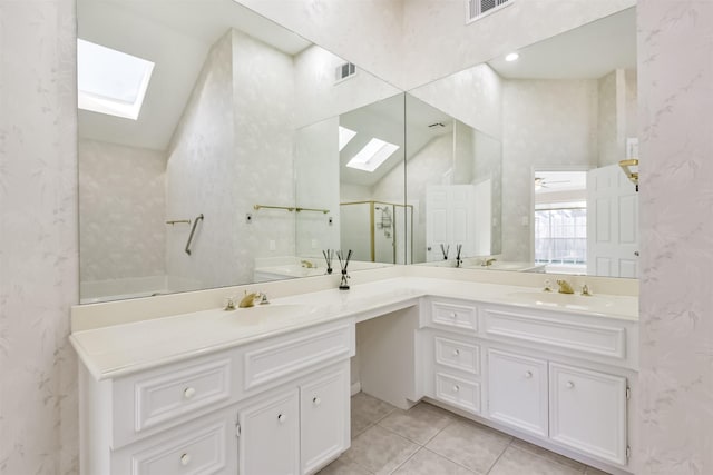 bathroom featuring visible vents, a shower stall, wallpapered walls, and a skylight