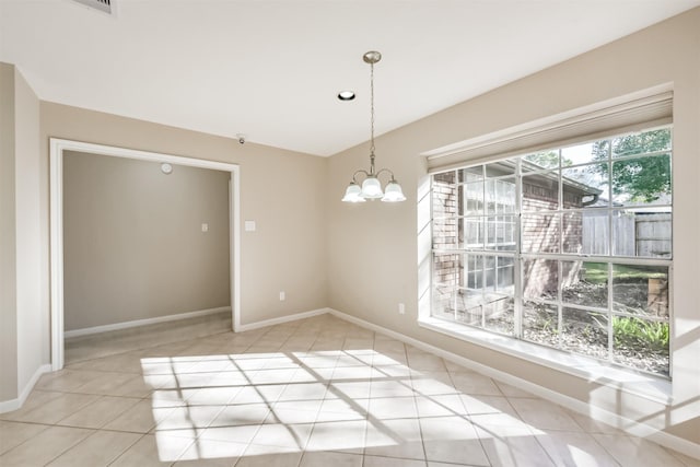 unfurnished dining area featuring an inviting chandelier, light tile patterned floors, and baseboards