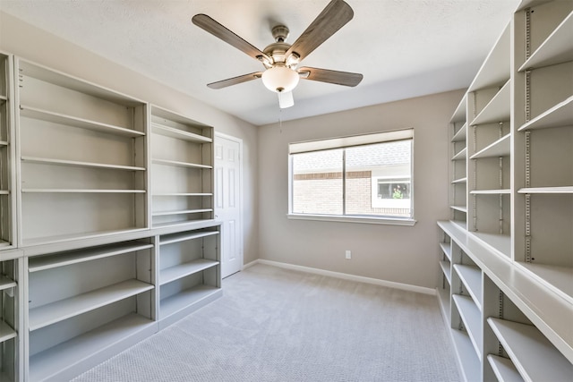 walk in closet featuring a ceiling fan and carpet flooring