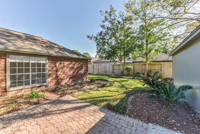 view of yard featuring a patio and fence