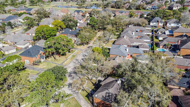 birds eye view of property with a residential view and a water view