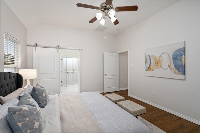 bedroom featuring ensuite bath, a barn door, baseboards, ceiling fan, and dark wood-style flooring