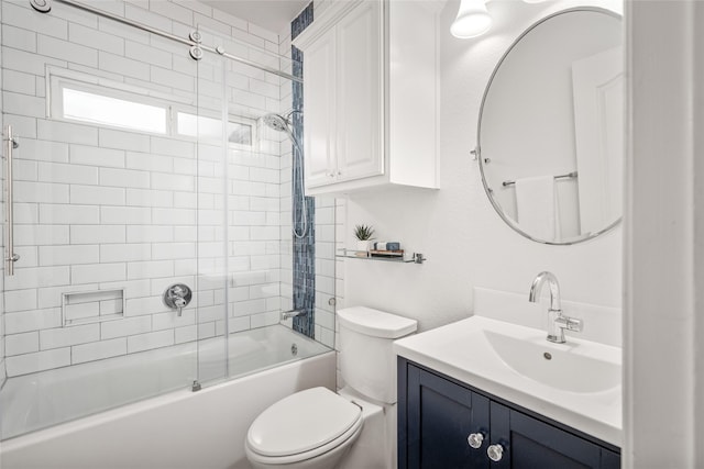 bathroom with vanity, toilet, and combined bath / shower with glass door